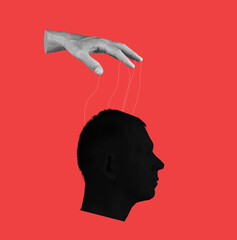 Control over human mind. Hand with strings and head on red background. Manipulation of person...
