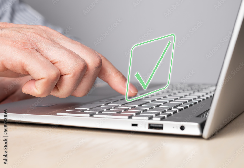 Poster hand at laptop keyboard with tick icon. approval of smth, idea, project or online verification of pr