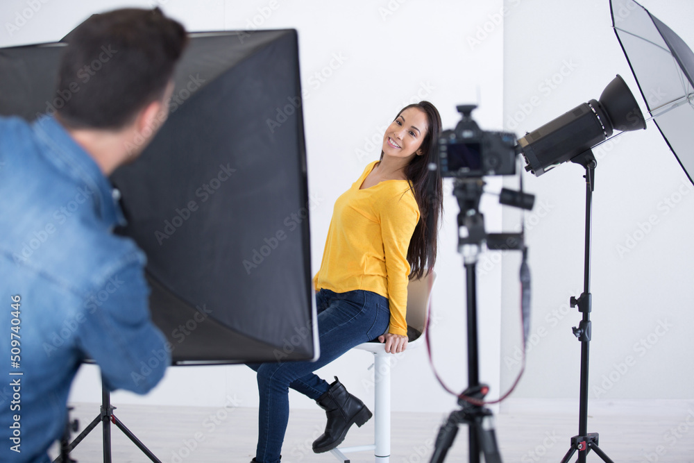 Wall mural woman posing for photographer during fashio shoot