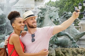 tourist couple woman and man taking holiday selfie