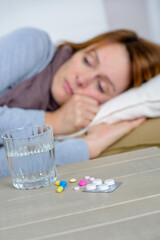 Obraz na płótnie Canvas picture of sad woman and pills