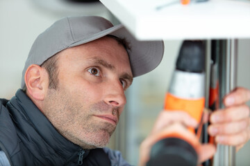 close view of man using cordless drill