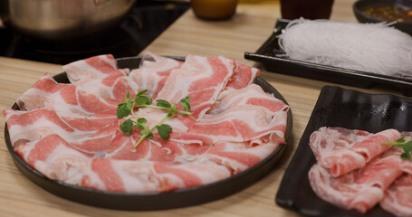 Fresh raw slice of pork meat for shabu shabu at restaurant