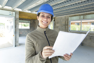 woman on building site holding paperwork © auremar