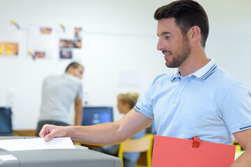 male teacher using photocopying machine