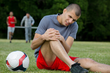 Fototapeta close-up of an injured male soccer player on field obraz