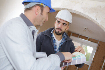 interior decorator with client discussing various paint colors