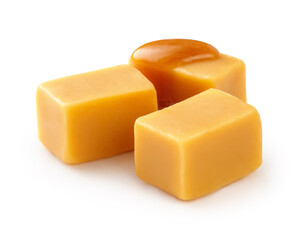 Caramel cubes with caramel sauce isolated on white background.
