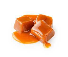 Caramel cubes with caramel sauce isolated on white background.