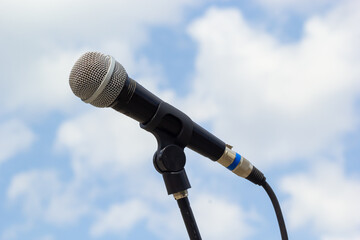 Microphone on sky background. The microphone is on the street. Concept - street music. Sound...