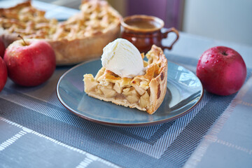 Piece of Fresh homemade Traditional Apple Pie with ice cream on a domestic kitchen