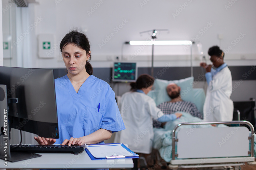 Poster front view of medical asisstant typing illness expertise on computer while in background physician d