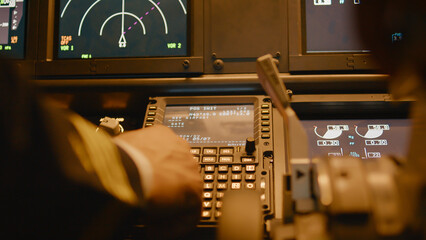 Captain inserting destination coordinates on cabin dashboard, using control panel command to fly...