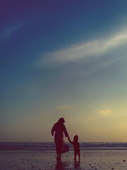 Fototapeta premium parent and child at sunset