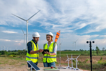 Engineer wearing uniform ,helmet inspection and survey work in wind turbine farms rotation to...