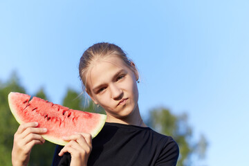 Portrait of attractive young girl with watermelon outdoor