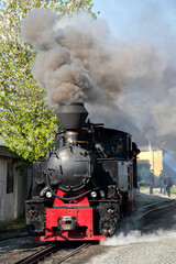 Obraz na płótnie Canvas Steam train Mocanita on a railway station, Romania