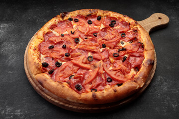 Pepperoni pizza on a round wooden board