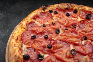 Pepperoni pizza on a round wooden board