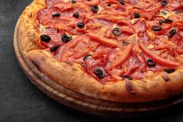 Pepperoni pizza on a round wooden board