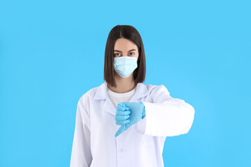 Attractive young female doctor on blue background