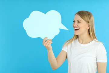 Young woman and talk cloud on blue background