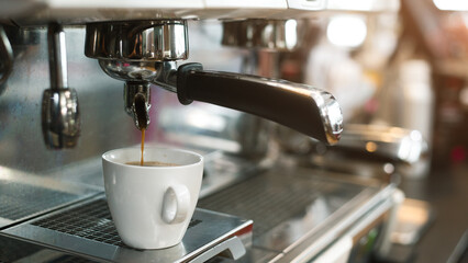 hot coffee on a table with cream being poured into it showing the texture