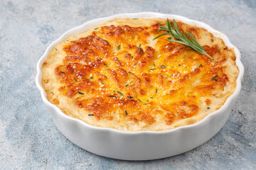 Potato gratin - graten (baked potatoes with cream and cheese) with rosemary and forks (Turkish name; Kremali patates)