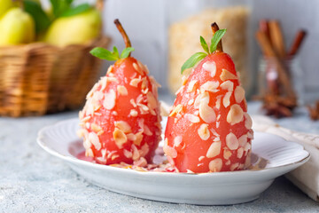 A poached pear dessert sprinkled with almond pieces. A taste of Turkish desserts, pear dessert....