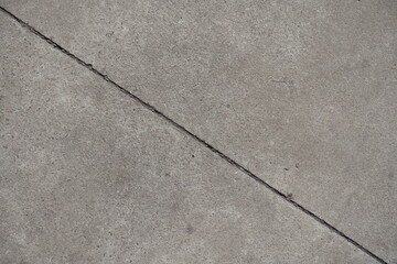 Obraz premium Single diagonal joint between two simple gray concrete slabs