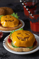 Funny monster chicken burgers with toast cheese, ketchup and cucumber. Halloween food