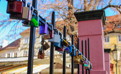 Fototapeta premium Colored locks at city background. bunch of metal locks. Heart locks
