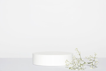 Abstract empty white podium and white flowers on grey background. Mock up stand for product presentation. 3D Render. Minimal concept.