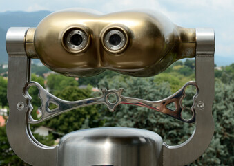 coin operated binoculars on the background of the city