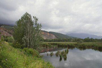 landscape with reflections in a lake in tuscany