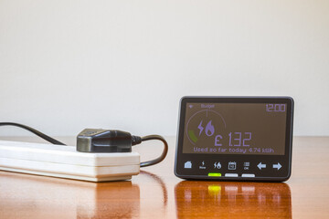 Smart meter placed next to an electrical extension cord with connected plug