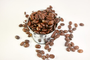 Metal bucket with roasted coffee beans.