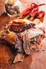 Beef jerky meat. Dried sliced meat on wooden table.