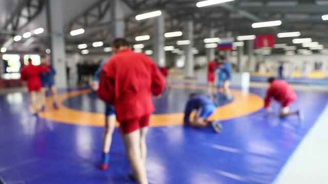 teenagers in kimono doing judo warm-up blurred focus