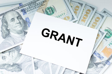 Office table a white card with text GRANT.