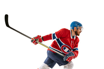 Young male hockey player in sports uniform and protective equipment training isolated on white background. Concept of sport, healthy lifestyle, motion, movement, action.