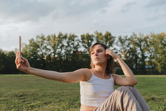 Young Female Taking Selfie Outside During The Golden Hour