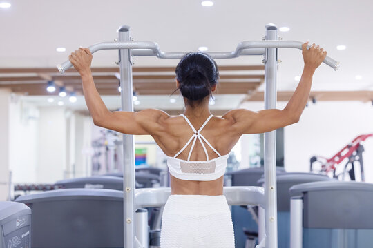 Back View  of Asian Woman Pull-Ups Exercise at the Gym