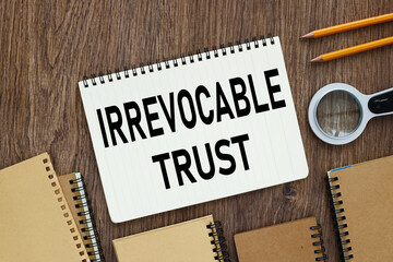 Irrevocable trust document with text on wooden background