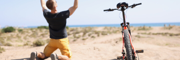 Male cyclist riding rejoicing of win competition