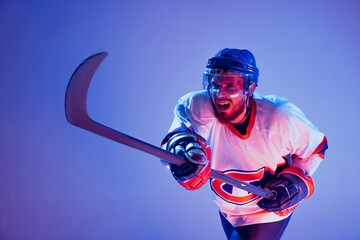 In action. Professional hockey player in sports uniform and protective equipment skating isolated...
