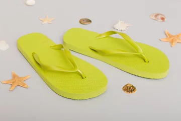 Deurstickers Beach accessories. Flip flops and starfish on colored background. Top view Mock up with copy space © sosiukin