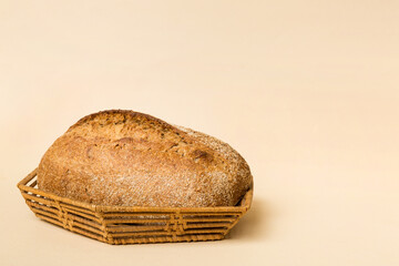 Freshly baked bread on basket against natural background. Perspective view bread copy space