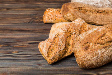 Homemade natural breads. Different kinds of fresh bread as background, perspective view with copy space