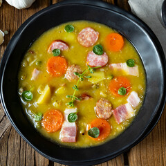 Hearty rustic pea soup with bacon and sausage